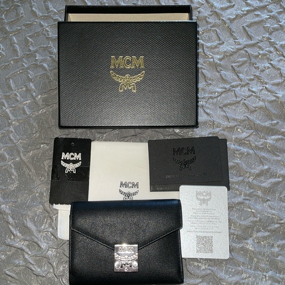 Brand New MCM black wallet pristine condition silver hardware comes with DB box